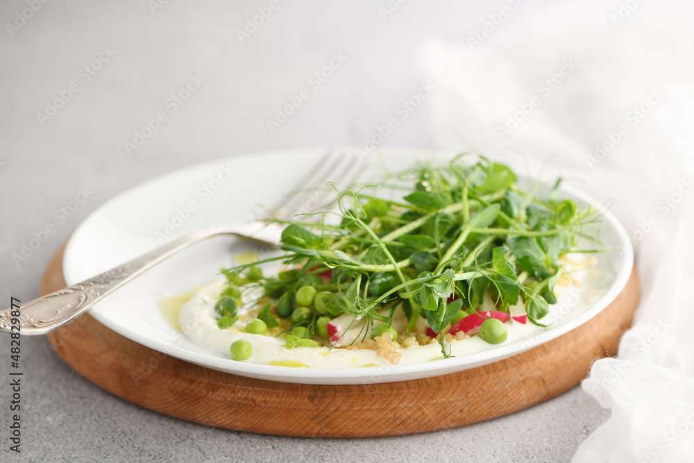 Vegan healthy salad made microgreen sprouts peas, quinoa, radish, mint and yogurt Vegan healthy salad made microgreen sprouts peas, quinoa, radish, mint and yogurt