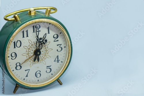 Vintage alarm clock on white background