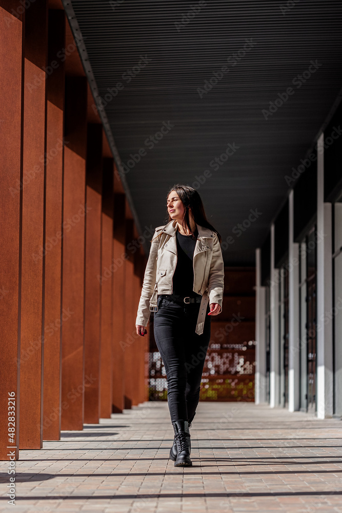 Beautiful stylish woman posing in fashionable clothes in leather shoes. Casual style. Urban fashion style. New collection of spring women's shoes