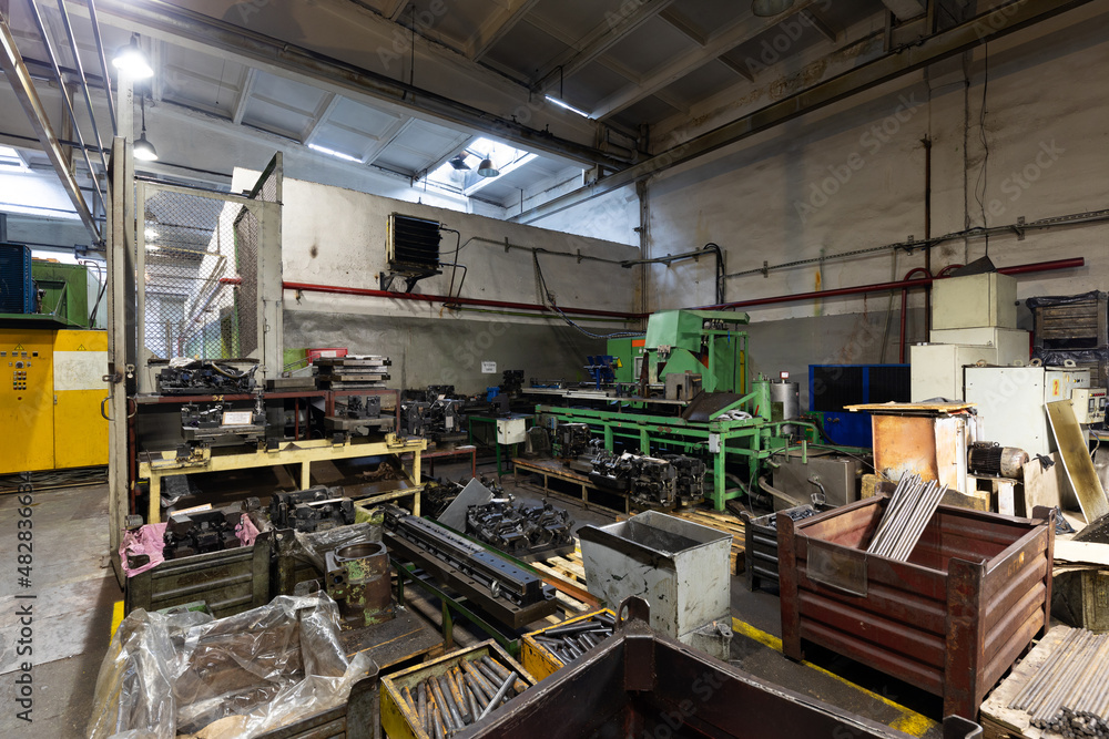 Photo of modern automatic automobile manufacturing workshop. The interior of a big industrial building of factory with steel constructions. Plant of car production. Industrial concept Photo of modern automatic automobile manufacturing workshop. The interior of a big industrial building of factory with steel constructions. Plant of car production. Industrial concept