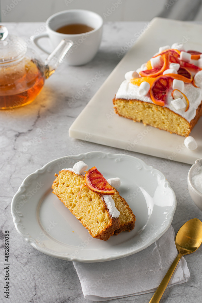 Slice of Orange pound cake with fresh bloody orange. Vertical Slice of Orange pound cake with fresh bloody orange. Vertical