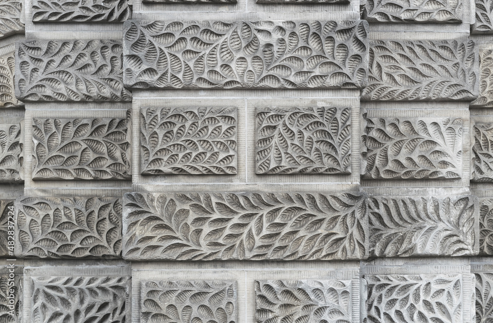 Stone wall with carved floral pattern