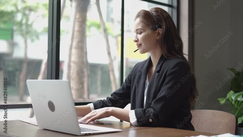 latin business woman using headset talking to customer online service . hispanic Female customer support operator in Call center agent service . listen take notes and typing on laptop keyboard latin business woman using headset talking to customer online service . hispanic Female customer support operator in Call center agent service . listen take notes and typing on laptop keyboard