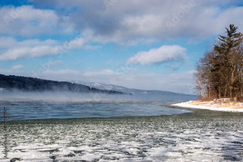 Winter scene with a lake and ice steam
