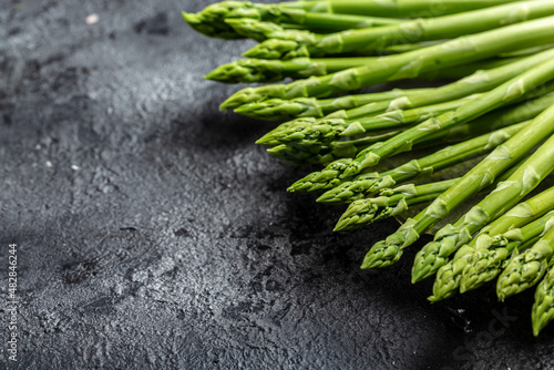Asparagus. bunch of fresh asparagus. banches of fresh green asparagus on dark background, Pickled Green Asparagus. Close up. Long banner format photo