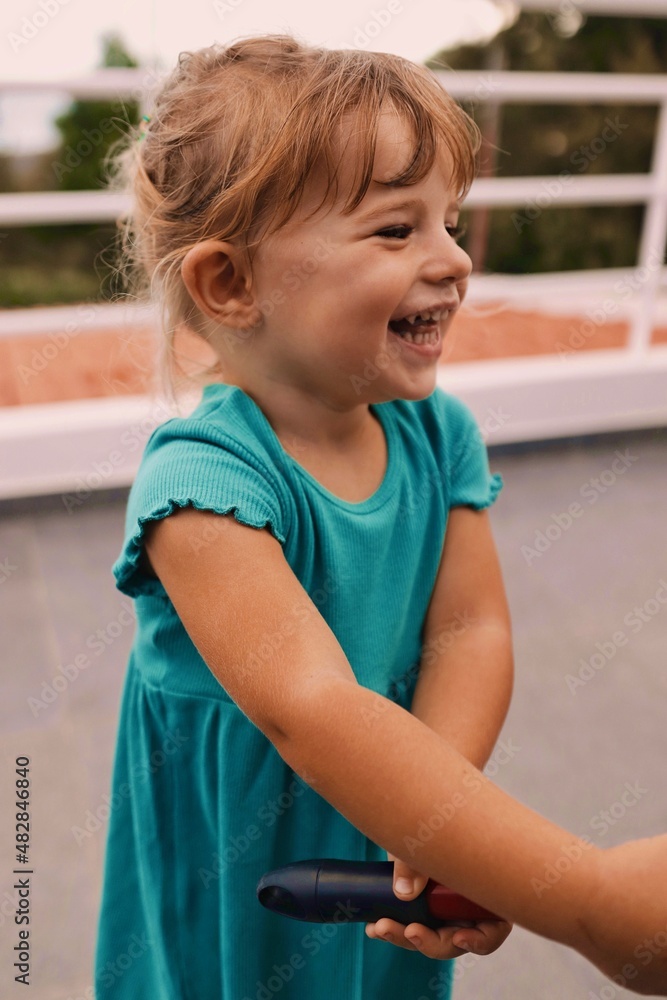 little girl in a dress playing on the terrace of madeira portugal having fun little girl in a dress playing on the terrace of madeira portugal having fun