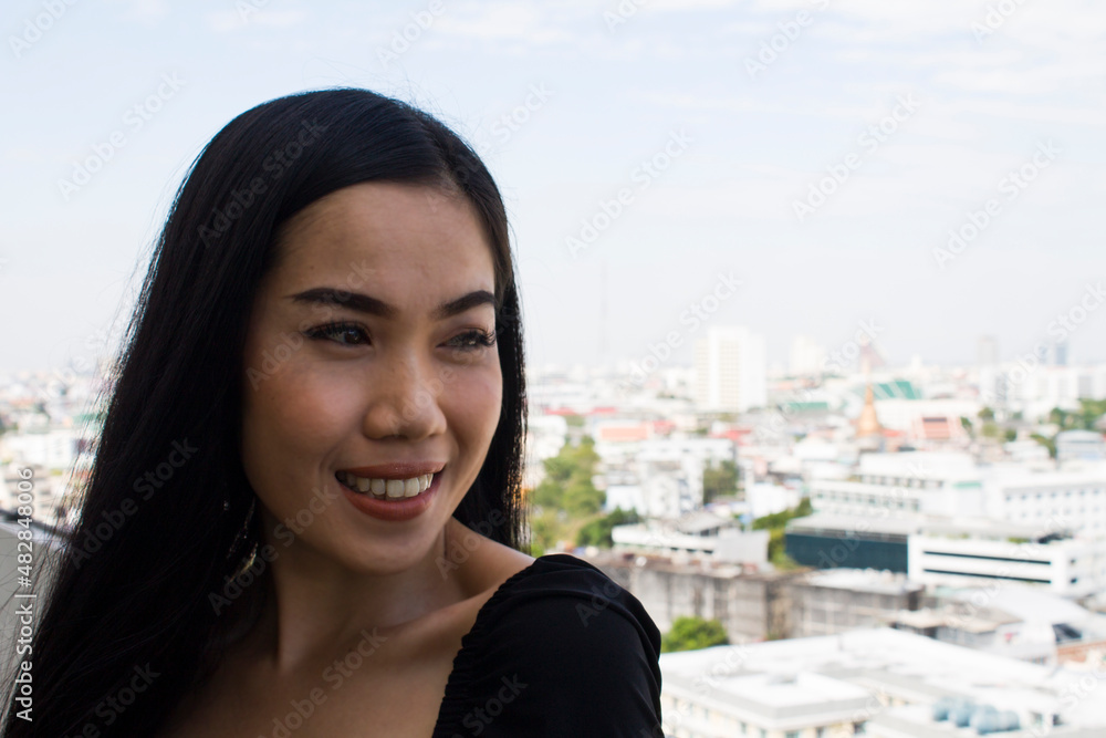 Young asian woman smiling happy on the city background Young asian woman smiling happy on the city background
