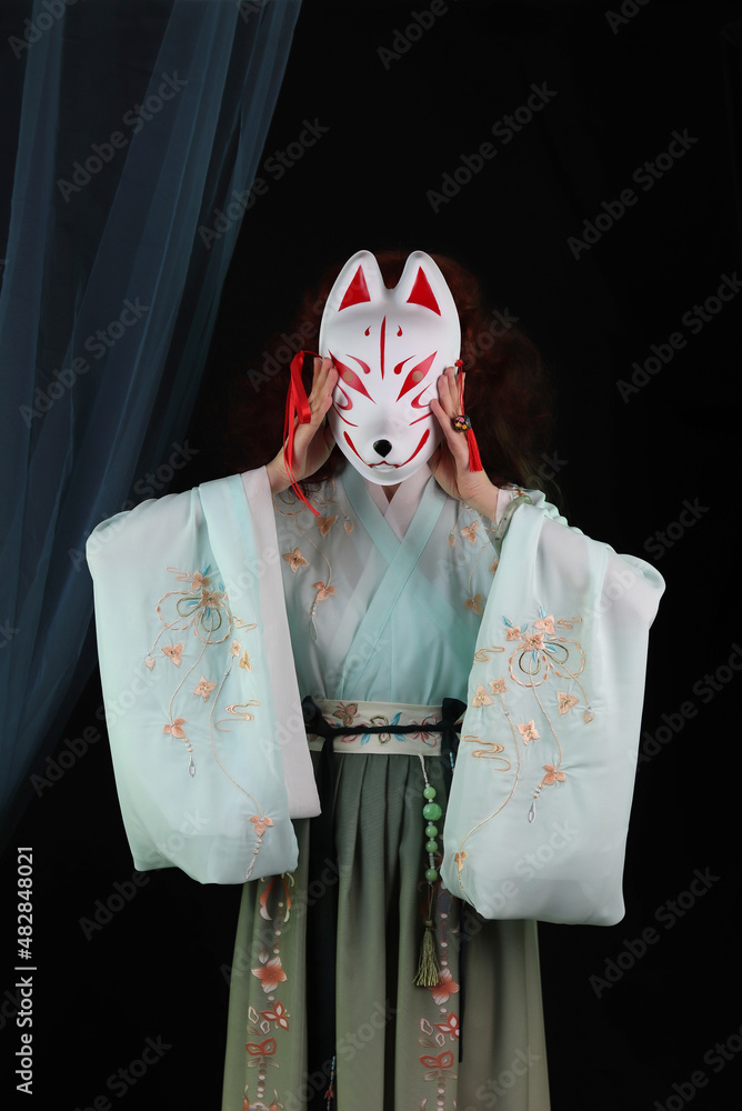 Woman wearing kimono, hanfu and a fox mask. Japanese, chinese
