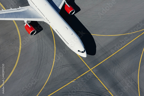 Aerial view of plane at airport. Airplane taxiing to runway before take off...