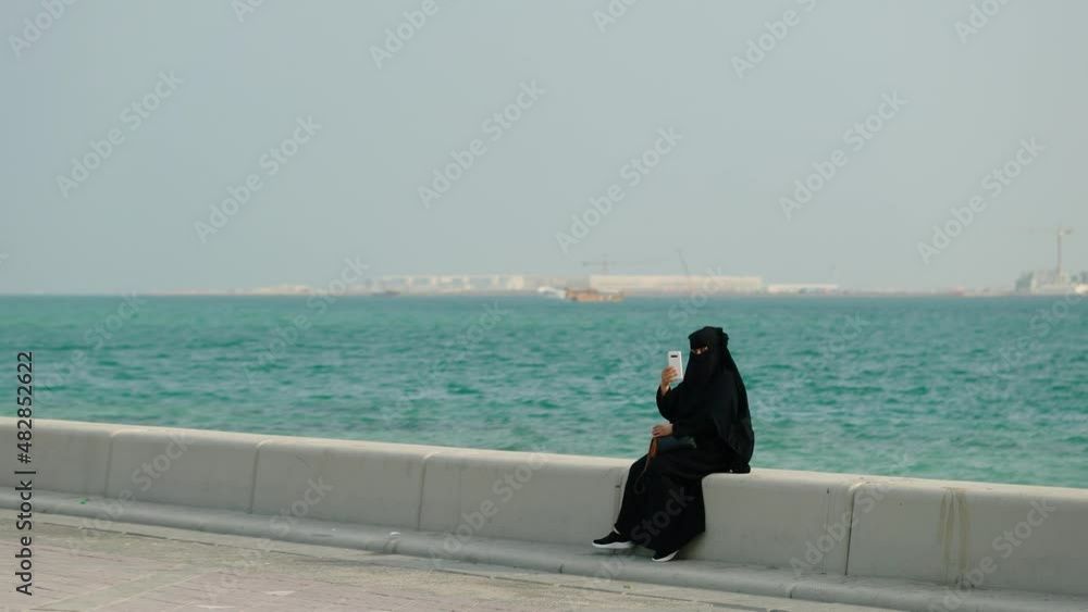 Woman in burqa uses smartphone at Doha Qatar
Woman in burqa uses smartphone at Doha Qatar