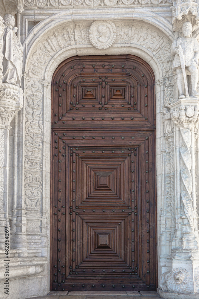 Giant wooden doors on a white marble building