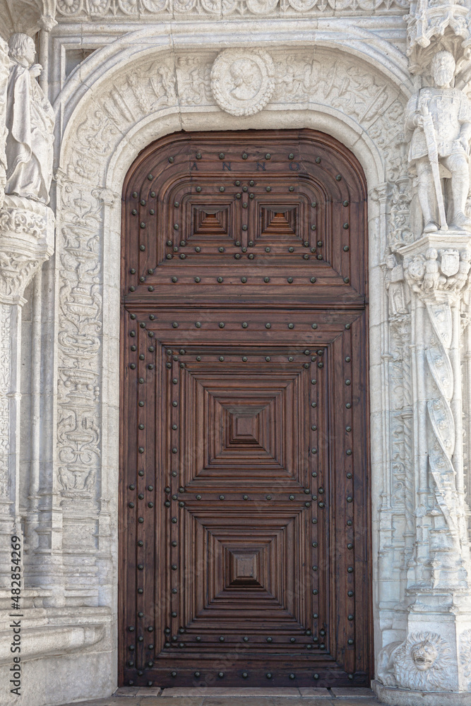 Giant wooden doors on a white marble building Giant wooden doors on a white marble building
