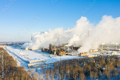 Industrial landscape. Panoramic view of the technological pipe and industrial infrastructure. Chemical production with red-white pipes and smoke is coming. Production buildings. photo