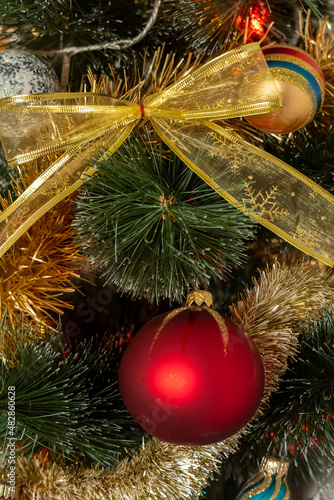 Decorative shiny golden colored transparent ribbon on Christmas tree