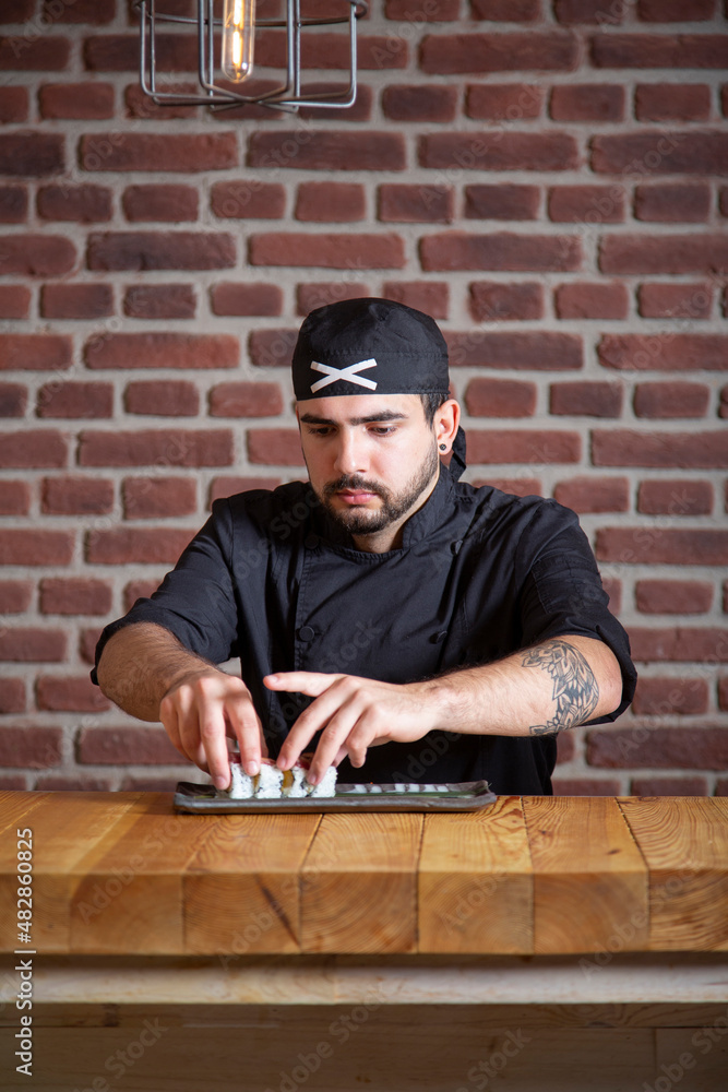 Chef serving sushi rolls with tuna Chef serving sushi rolls with tuna