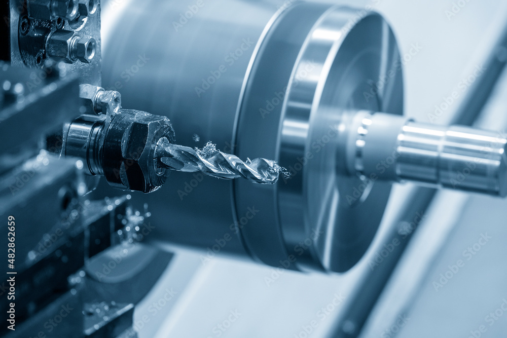 The CNC lathe machine hole cutting the metal shaft parts. The CNC lathe machine hole cutting the metal shaft parts.