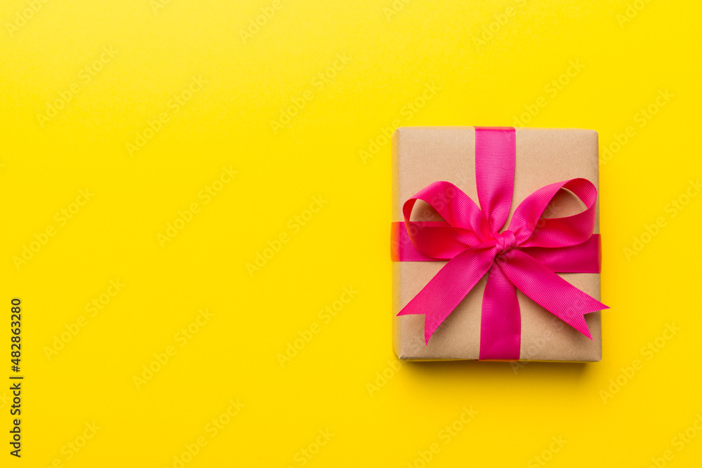 Holiday present box over colored background, top view. Copy space for design Holiday present box over colored background, top view. Copy space for design