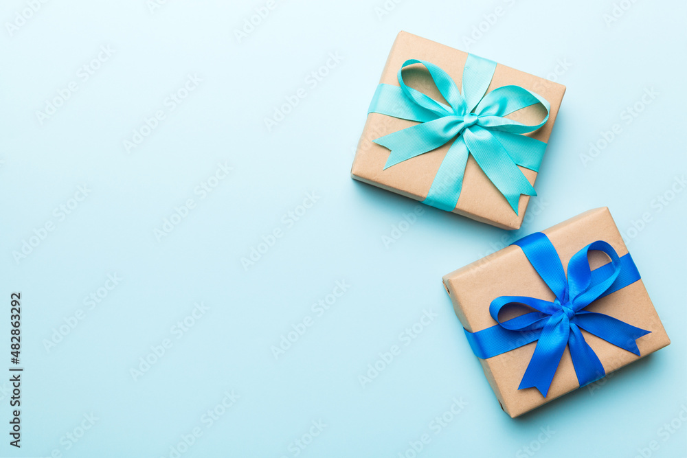 Holiday present box over colored background, top view Holiday present box over colored background, top view