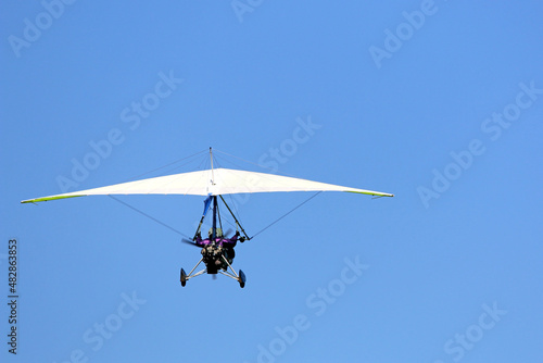 Valokuva Ultralight airplane flying in a blue sky