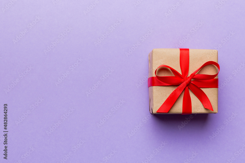 Valentine day composition: red gift box with bow and heart. Christmas present. View from above. Space for text. Holday greeting card Valentine day composition: red gift box with bow and heart. Christmas present. View from above. Space for text. Holday greeting card