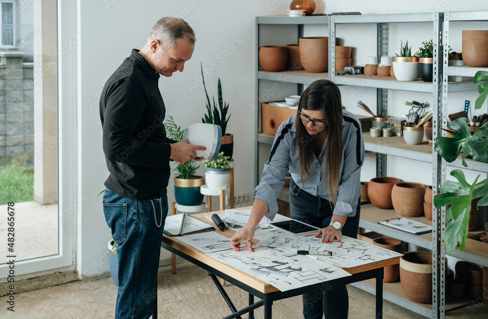 Team of Furniture Designer Working Together on a Plant Stand Design for Handmade Flower Pots Team of Furniture Designer Working Together on a Plant Stand Design for Handmade Flower Pots