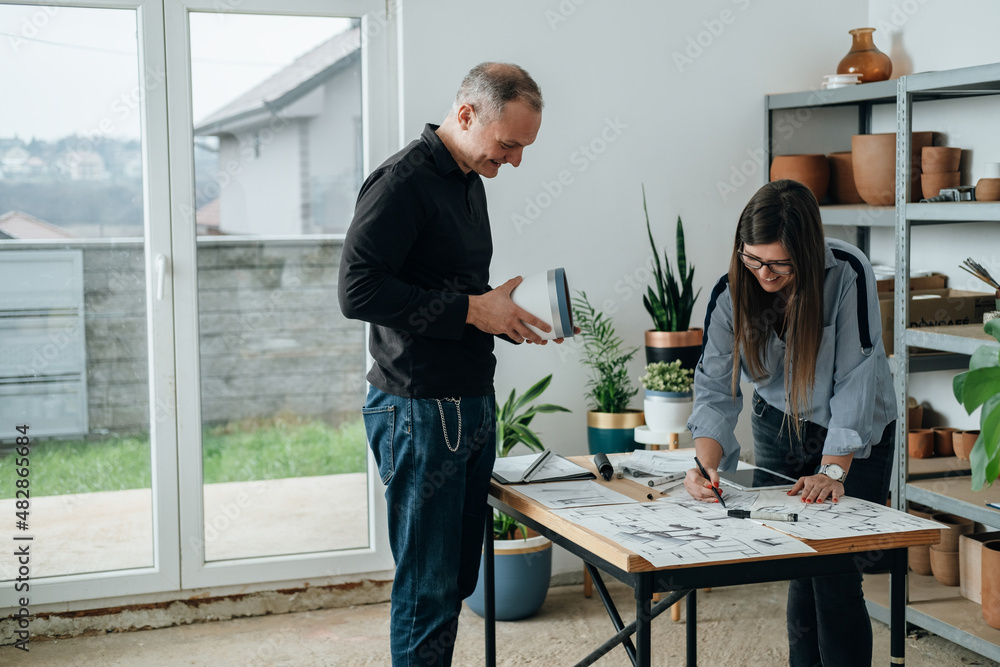 Team of Furniture Designer Working Together on a Plant Stand Design for Handmade Flower Pots Team of Furniture Designer Working Together on a Plant Stand Design for Handmade Flower Pots