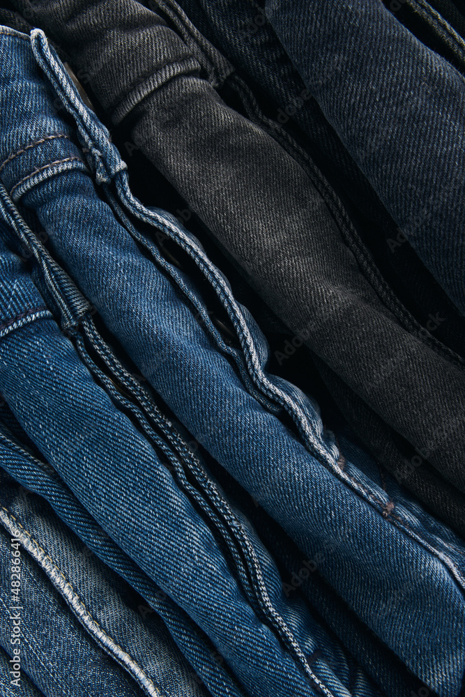 Stack of Various Shades Of Blue Jeans On White Background Denim jeans texture. Denim background texture for design. Canvas denim texture. Blue denim that can be used as background. Stack of Various Shades Of Blue Jeans On White Background Denim jeans texture. Denim background texture for design. Canvas denim texture. Blue denim that can be used as background.