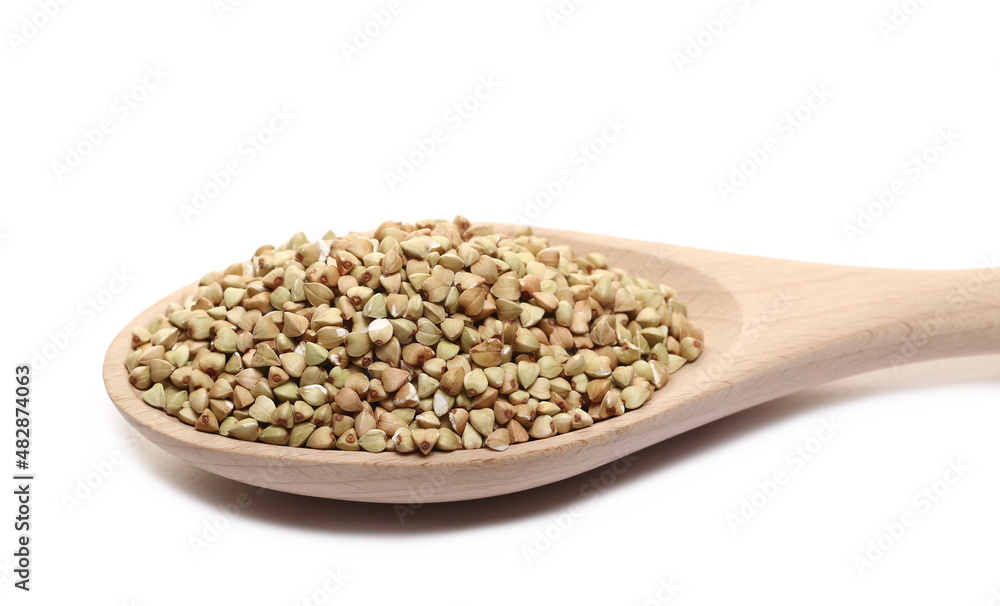 Buckwheat pile in wooden spoon isolated on white Buckwheat pile in wooden spoon isolated on white