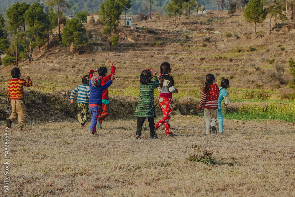 group of children running on the field