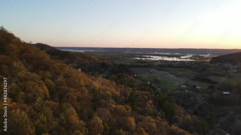 Amazing aerial view in autumn around the mountain, past the farm fields, scenes of the Mississippi River in the distance, to the shrine building nestled into the forest. Amazing aerial view in autumn around the mountain, past the farm fields, scenes of the Mississippi River in the distance, to the shrine building nestled into the forest.