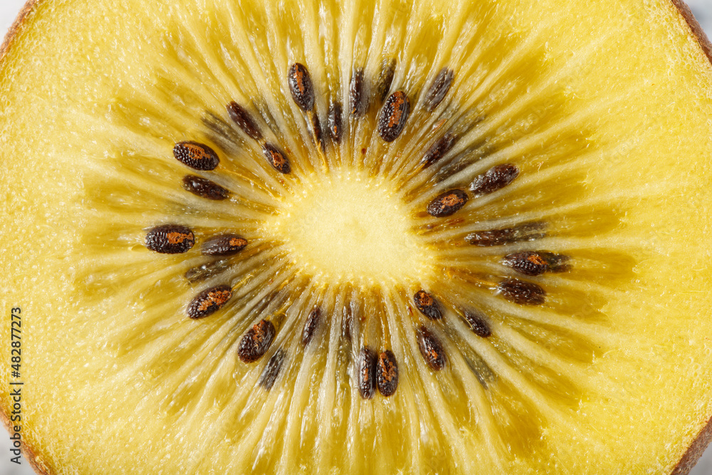 Fresh juicy kiwi gold slice closeup top view. Tropical fruit texture background. Macro detail Fresh juicy kiwi gold slice closeup top view. Tropical fruit texture background. Macro detail