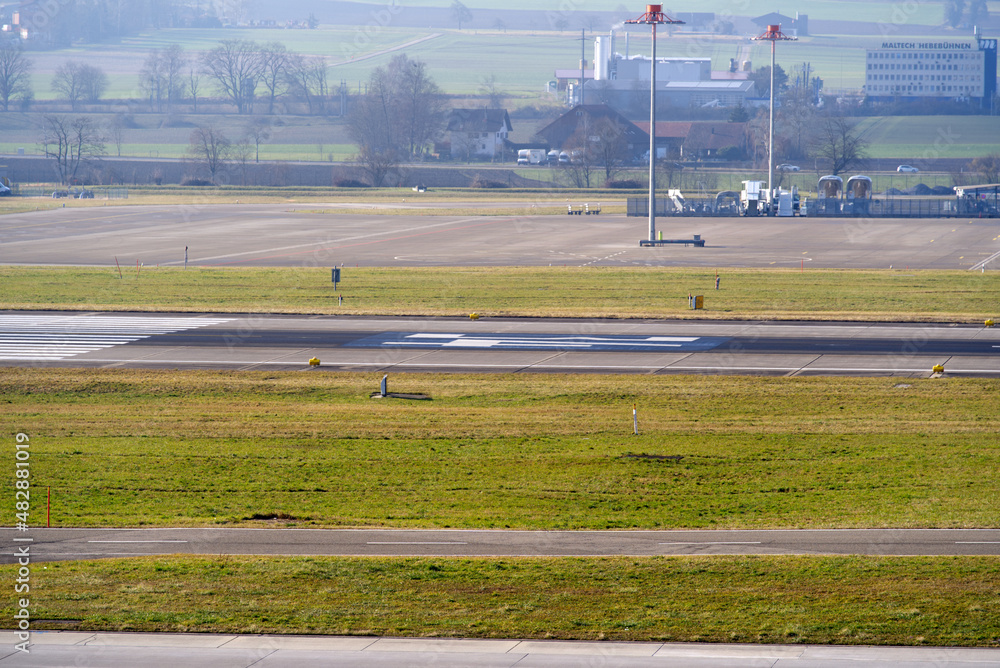 Empty runway at Zürich Airport on a cloudy winter day. Photo taken January 19th, 2022, Zurich, Switzerland. Empty runway at Zürich Airport on a cloudy winter day. Photo taken January 19th, 2022, Zurich, Switzerland.
