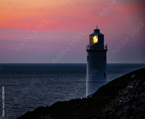 Lighthouse and sunset by the sea in Cornwall, United Kingdom