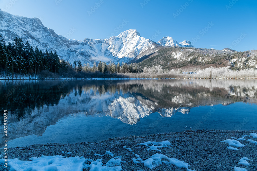 Dreamlike Winter wonderland in Almtal, Salzkammergut. Frozen Trees, snowcaped mountains, crystal clear Almsee, Totes Gebirge, Upper Austria