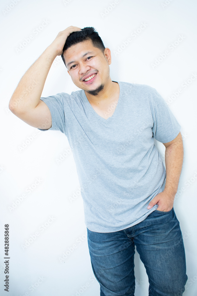 Close up portrait of young man with hands behind head Close up portrait of young man with hands behind head