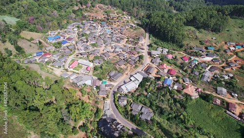 Aerial view of traditional local tribe village neightborhood in the valley surrounded by tropical rainforest at countryside photo