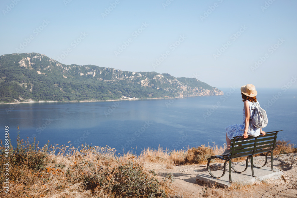 girl tourist sitting on a bench at  the observation deck