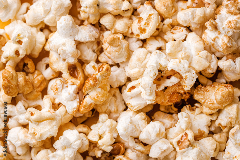 Closeup popcorn abstract background on yellow. Copy space Closeup popcorn abstract background on yellow. Copy space