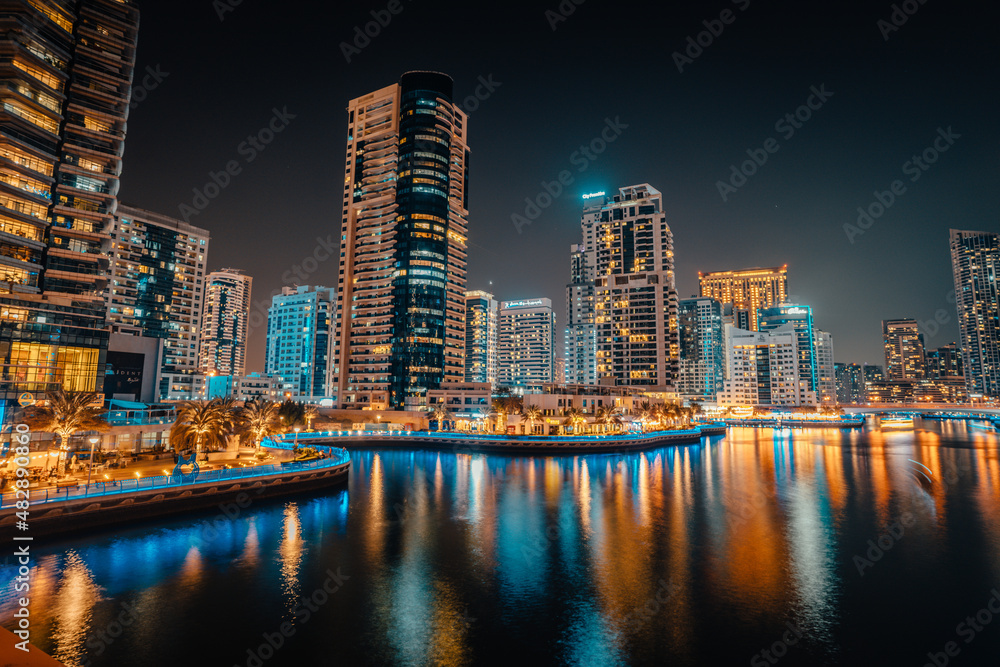Fantastic nighttime skyline with illuminated skyscrapers. Dubai, UAE