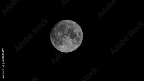 Full Earth's Moon glow on black background. Image in high resolution. Bright lunar satellite