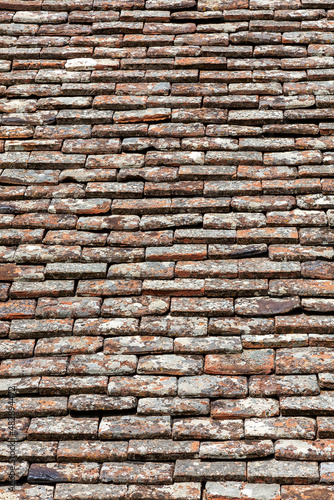 Old roof tiles background of a stone clay brick pattern and orange red texture found on the Mediterranean island of Cyprus, stock photo image