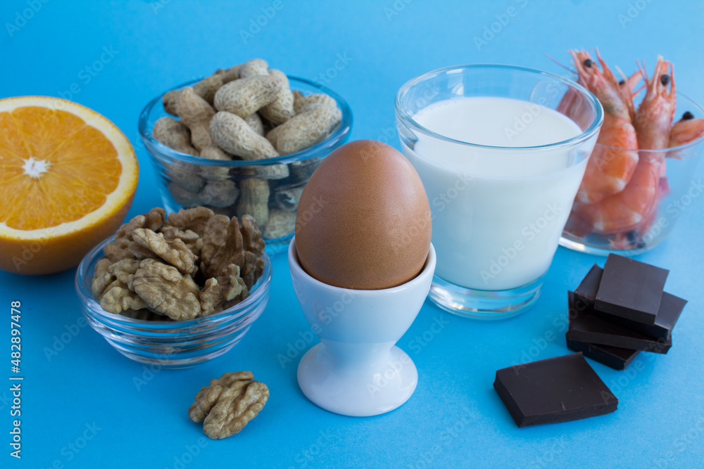 Close-up on food allergens on the blue background. Copy space. Food allergy concept. Close-up on food allergens on the blue background. Copy space. Food allergy concept.