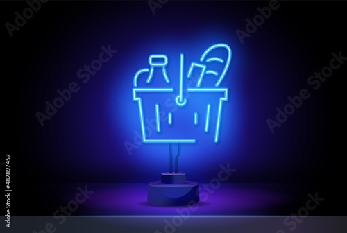 Neon Grocery Cart. Basket with vegetables, fruits, milk and bread. Concept for Grocery Store, Consumer Basket. Glowing neon sign on a dark background.