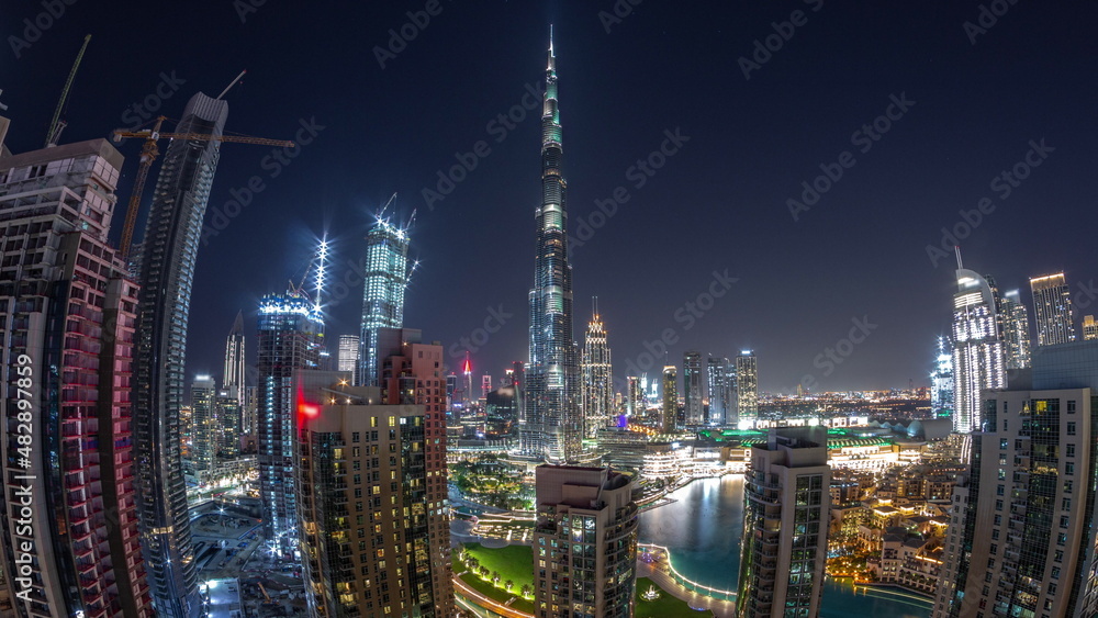 Naklejka premium Panorama of Dubai Downtown cityscape with tallest skyscrapers around aerial all night timelapse.