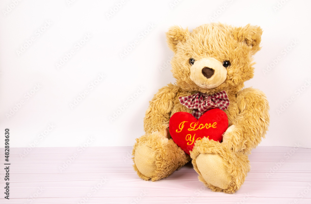 Teddy bear with a heart on a light background. Children's toy, children's room. Valentine's Day Teddy bear with a heart on a light background. Children's toy, children's room. Valentine's Day