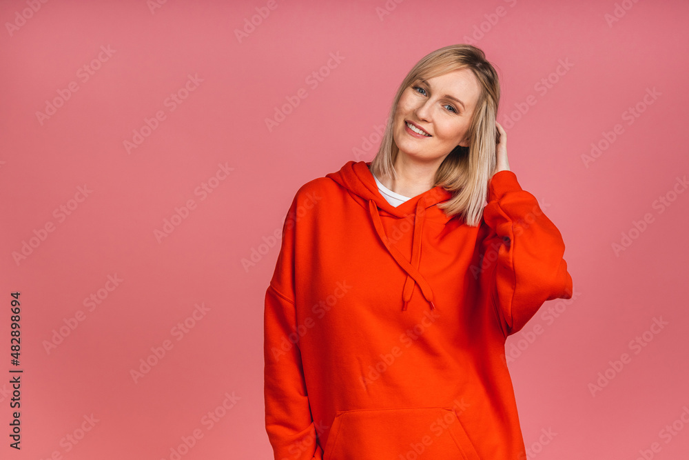 Portrait of a young beautiful cute cheerful blonde woman smiling looking at the camera isolated over pink background. Portrait of a young beautiful cute cheerful blonde woman smiling looking at the camera isolated over pink background.
