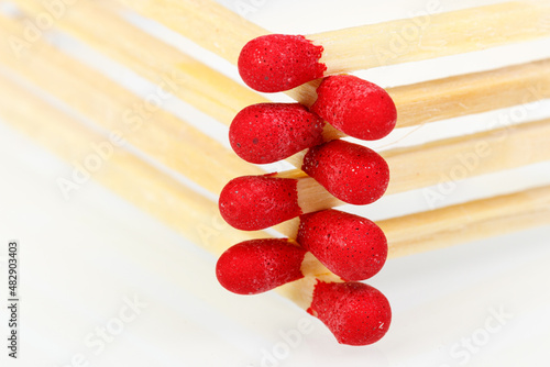 matches with a red head on a white background