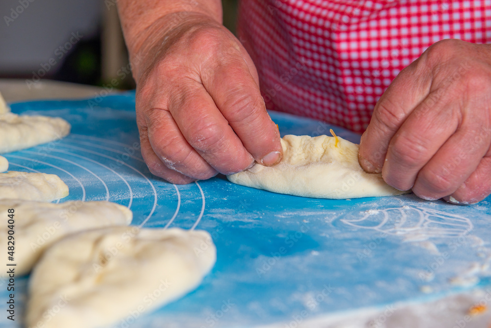 a woman makes a lot of pies out of dough. High quality photo