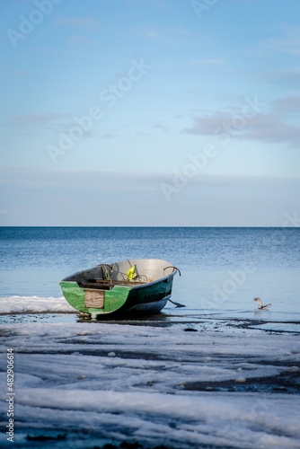 Fototapeta Naklejka Na Ścianę i Meble -  Fishing boat on the sea beach in winter, selective focus