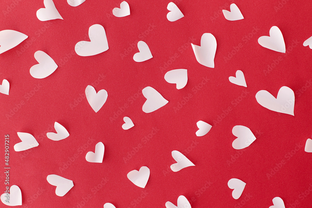 Stylish hearts composition on red background flat lay. Valentines day card. Cute little white hearts cut outs on red paper. Happy Valentine's Day! Love concept Stylish hearts composition on red background flat lay. Valentines day card. Cute little white hearts cut outs on red paper. Happy Valentine's Day! Love concept